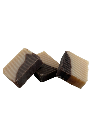 Image of Three (3) Seamoss Coconut Soap Bars by Sebi's Daughters under a transparent background that show a golden yellow, and dark brown blend in the soap in it's all natural, alkaline vegan finished hue while being apart of the summer 2025 bath and body and soap collection at Sebi's Daughters.