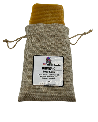 Sebiβs Daughters Organic Turmeric Soap bar on a white background, showcasing its natural golden color and smooth texture, made with shea butter, coconut oil, and organic turmeric for an alkaline lifestyle.