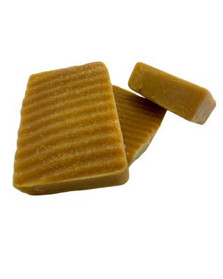 Three (3) Sebiβs Daughters Organic Turmeric Soap bar on a clear background, showcasing its natural golden color and smooth texture, made with shea butter, coconut oil, and organic turmeric for an alkaline lifestyle.