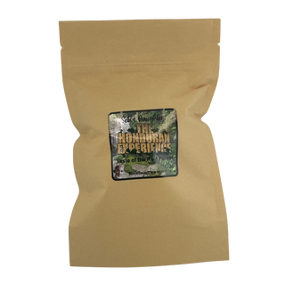 A kraft paper tea bag package with a label reading "Sebi's Daughters The Honduran Experience - Taste of the Rain Forest." The label features a lush green forest background with bold golden and white text. The product appears to be a natural tea blend.