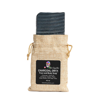 Image of Charcoal Onyx Soap by Sebi's Daughters.  The soap is a charcoal black soap and the package is burlap packaging that closes by a drawstring on each side.